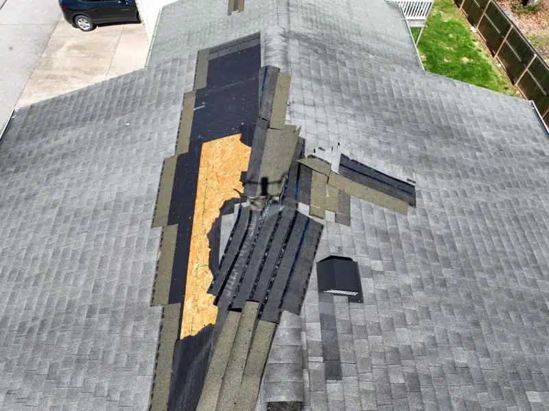 Drone view of a damaged roof from a storm