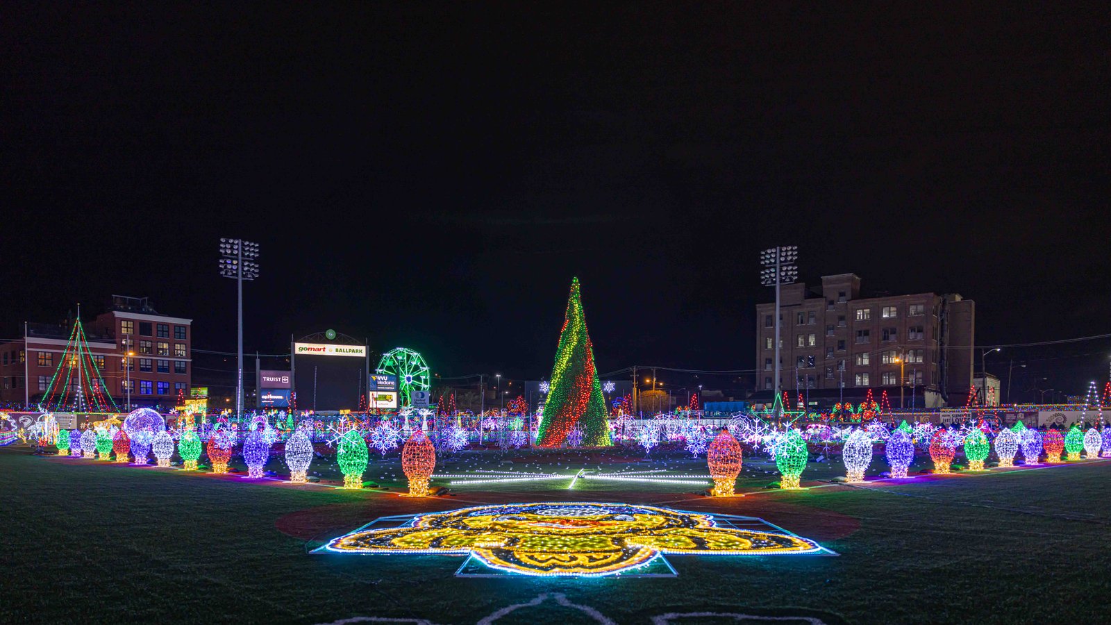 A Tapestry of Lights: Charleston's Holiday Panorama Expansive view of Charleston's holiday lights and decorations at GoMart Ballpark, presented by UA-Visions.