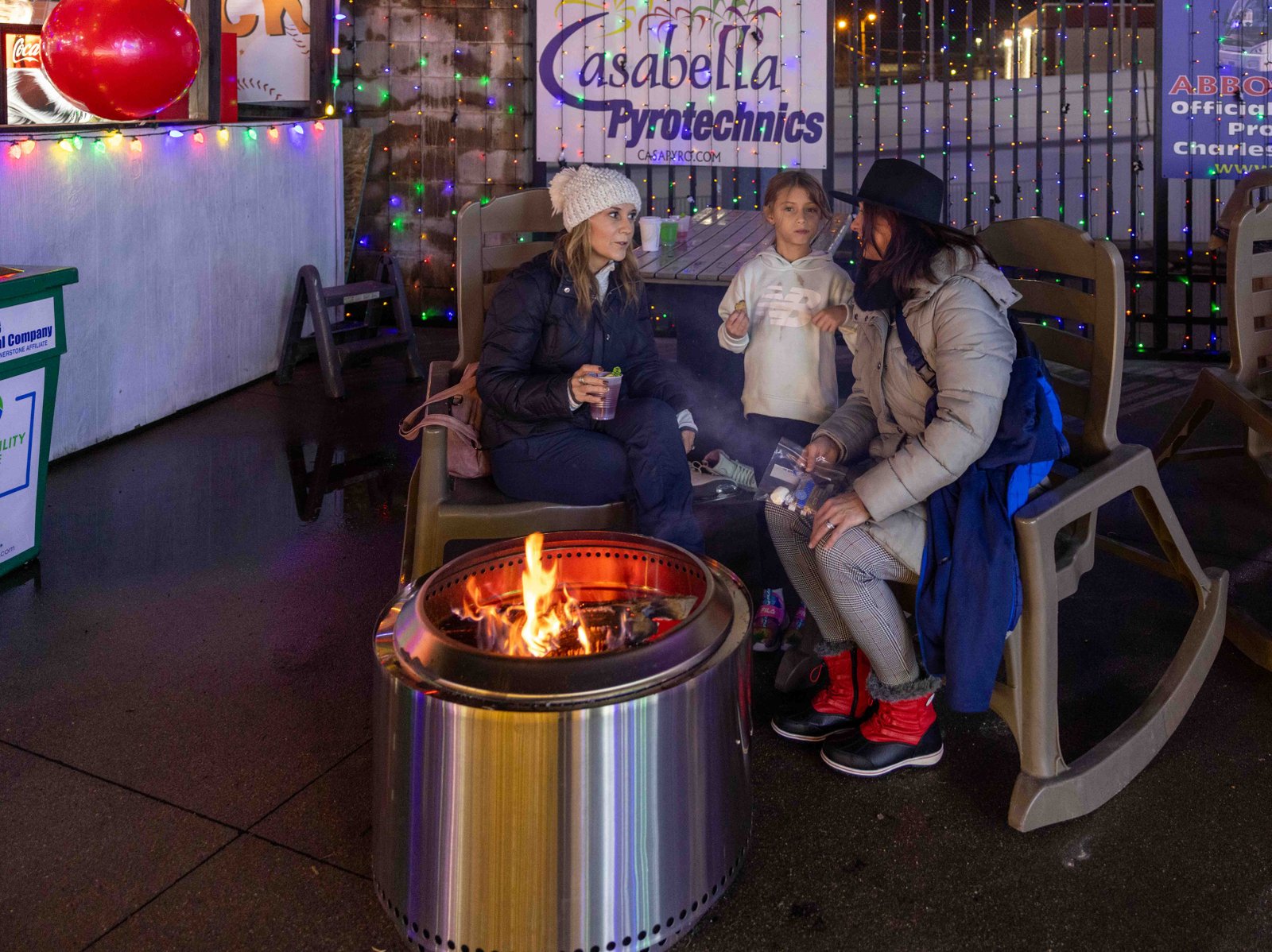Holiday Fire Pit Family Bonding Family enjoying warmth by the fire pit at Charleston's Light the Night, captured by UA-Visions.